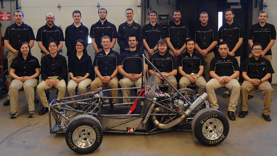 The 2015 Automotive Engineering Technology students posing with their formula-style racing car in front of them