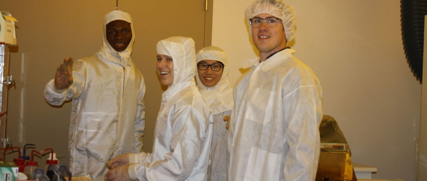 Students in the lab wearing safety lab suits
