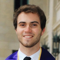 Jake B. Anderson posing in his graduation gown