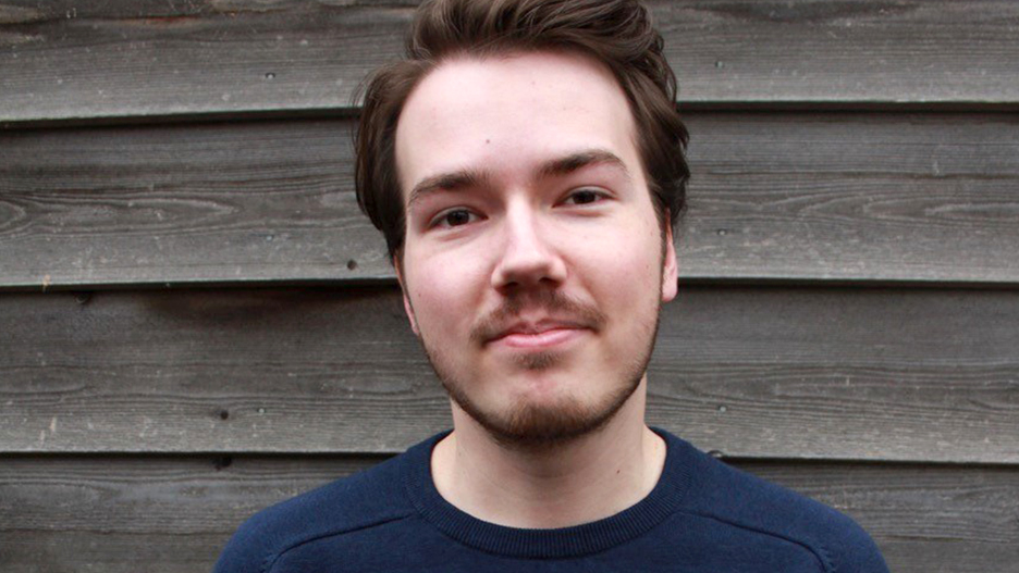 a person with a beard and mustache smiling