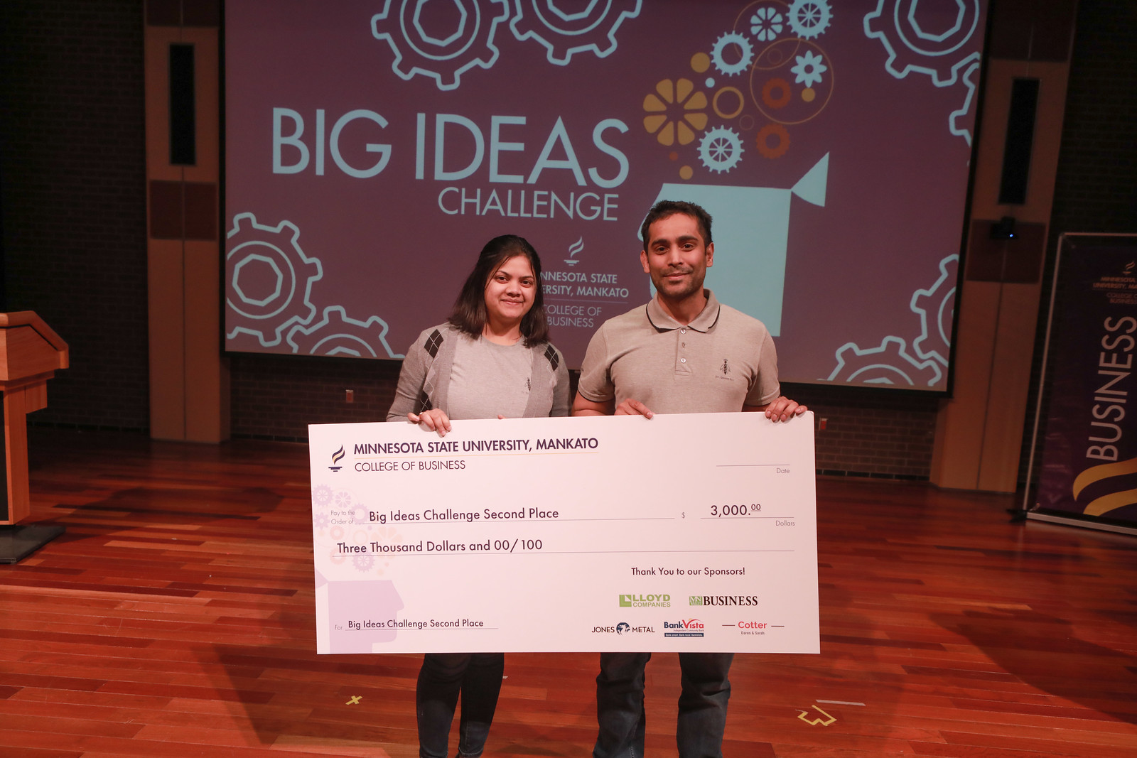 a person and person holding a large check