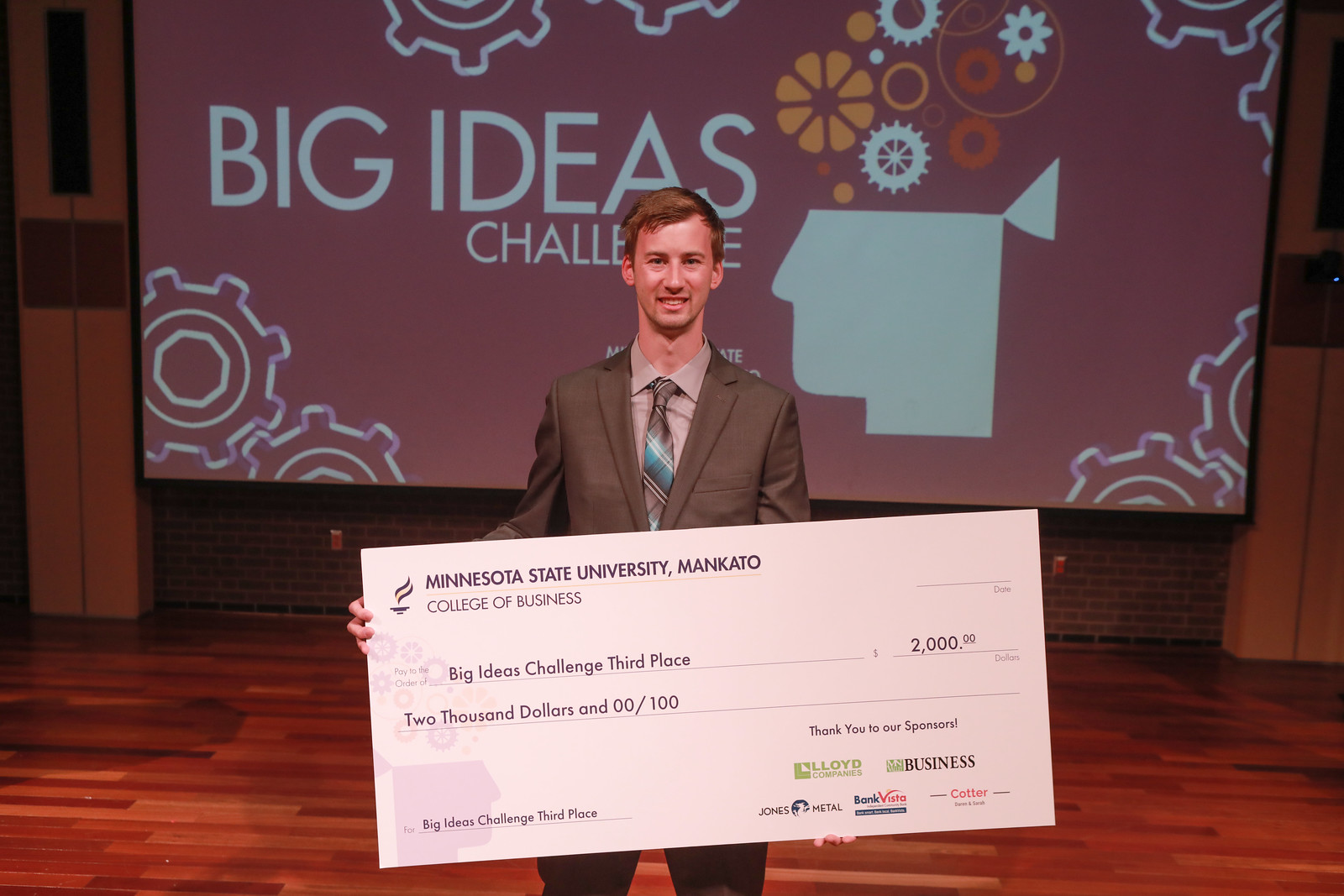 a person holding a large check