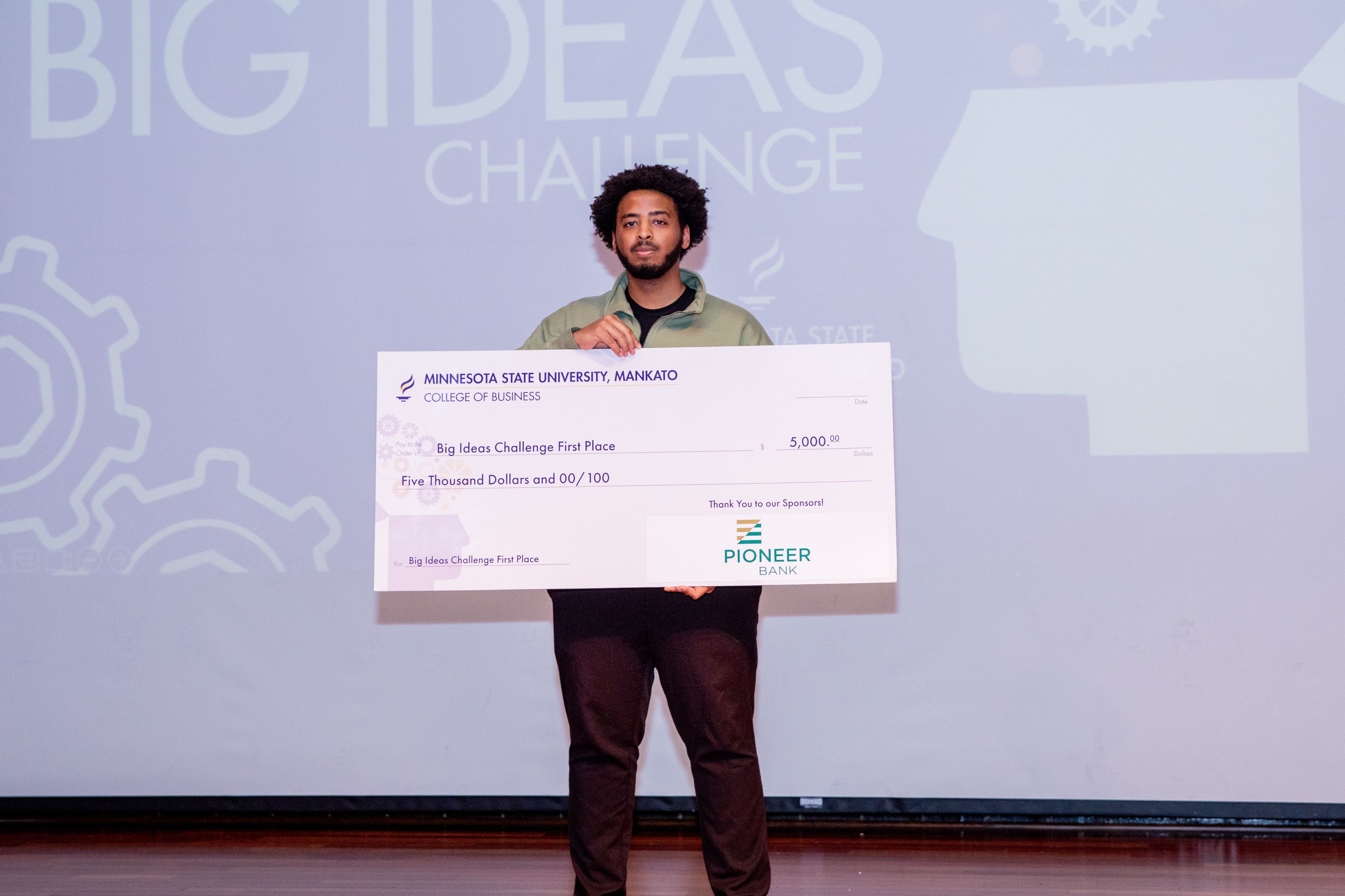 Melan Shifa posing with the Big Ideas Challenge award