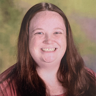 a person with long hair smiling