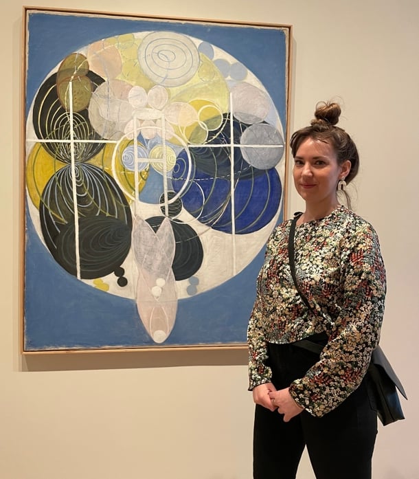 a person standing in front of a painting