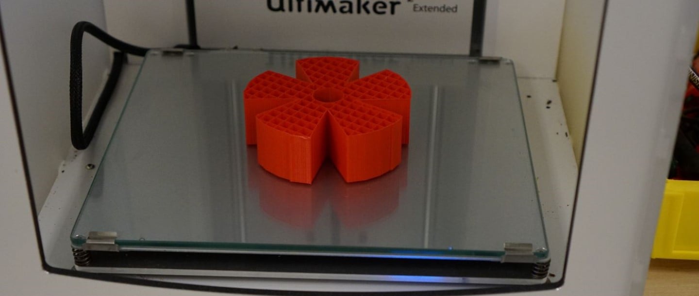 A 3D printing ultimaker that has printed a red object