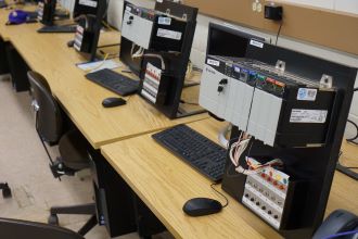 Programmable logic controllers (PLC) equipment on desks in the manufacturing automation laboratory