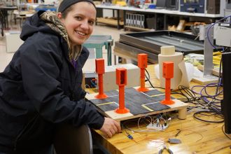 A female student working on an automation project in the manufacturing automation laboratory