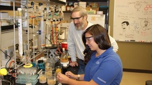Dr. Brian Groh working with a student on a project in the chemistry lab