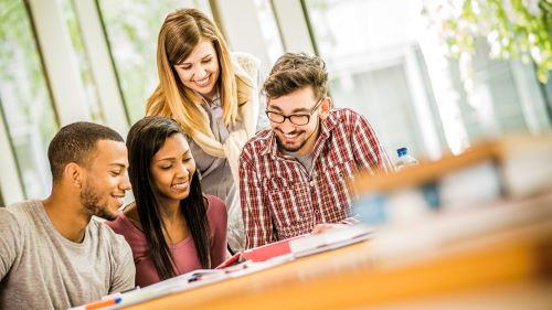 4 students working on a project together at a table