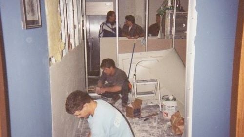 Construction Management students remodeling inside the job-site trailer from the 2000s