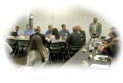 A group of advisory board members sitting at tables during a meeting
