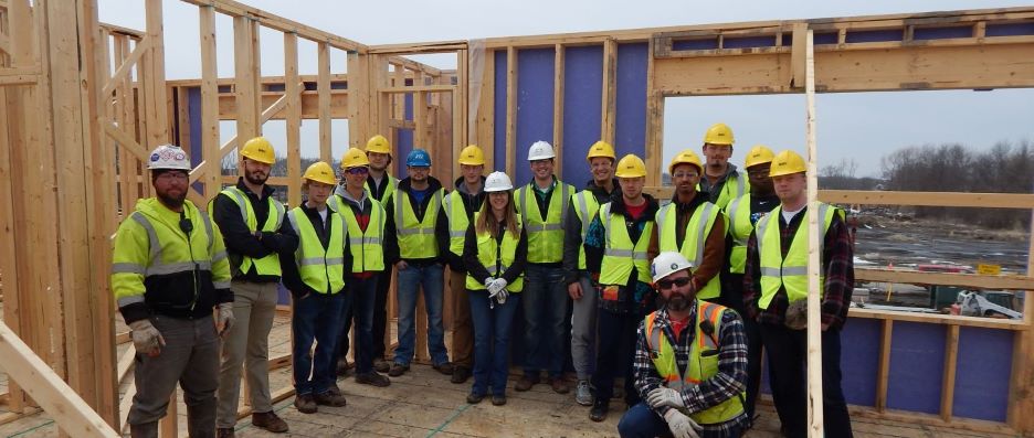 Construction Management students posing with Greystone Construction Company workers during site tours of Mankato senior housing project in Pillars of Mankato