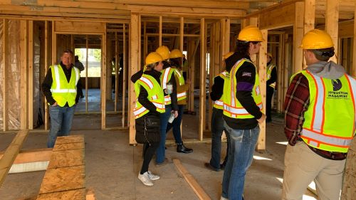 Construction Management students touring a construction site at the 2019 Orion and Niche development