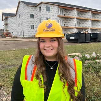 Michaela Sylvester posing at construction site