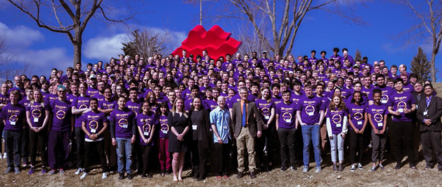 A 'You Belong' student organization group of faculty and students posing outside on campus
