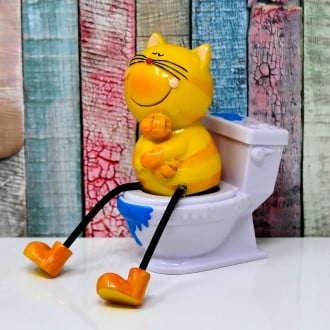 a toy cartoon cat sitting on a toilet