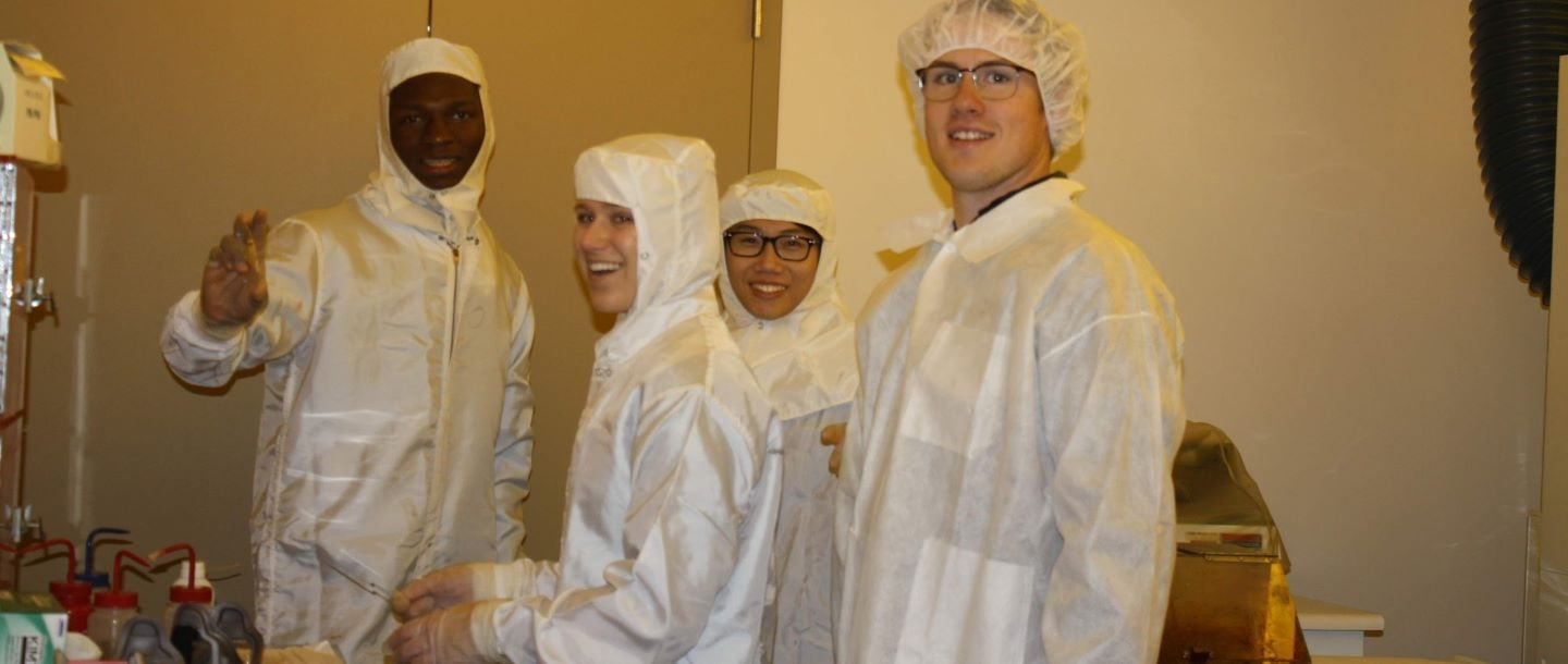 Students in the lab wearing lab suits