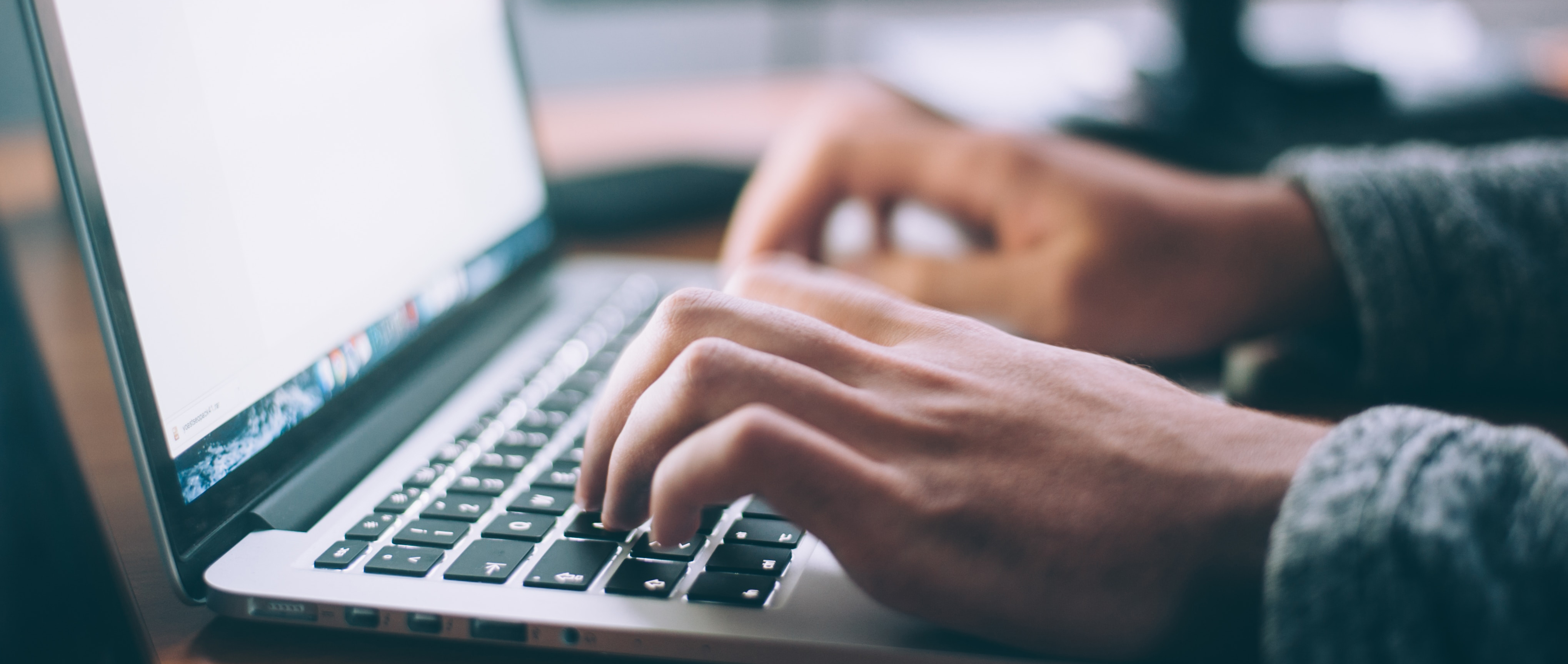 a person typing on a laptop